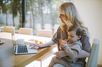 Mother-with-child-on-lap-looking-at-laptop