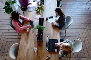 Team-working-on-laptops-shared-table